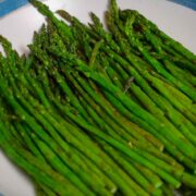 Roasted asparagus in blue and white serving plate