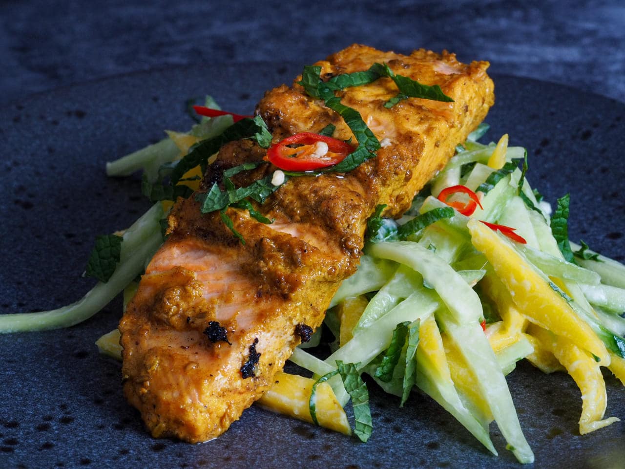 Grilled Turmeric salmon with mango and cucumber salad
