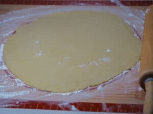 Rolled pie crust on a silicone mat