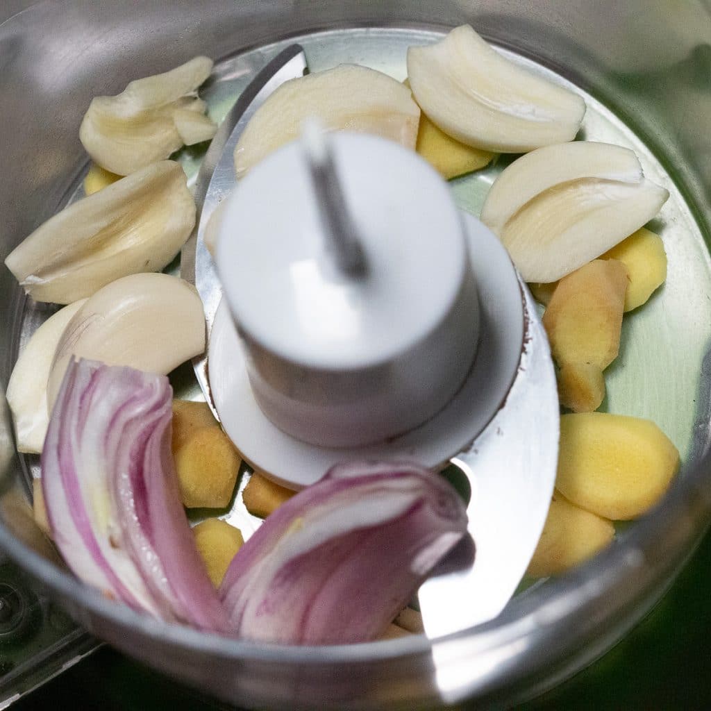 slices of garlic, ginger and shallots in a food processor.