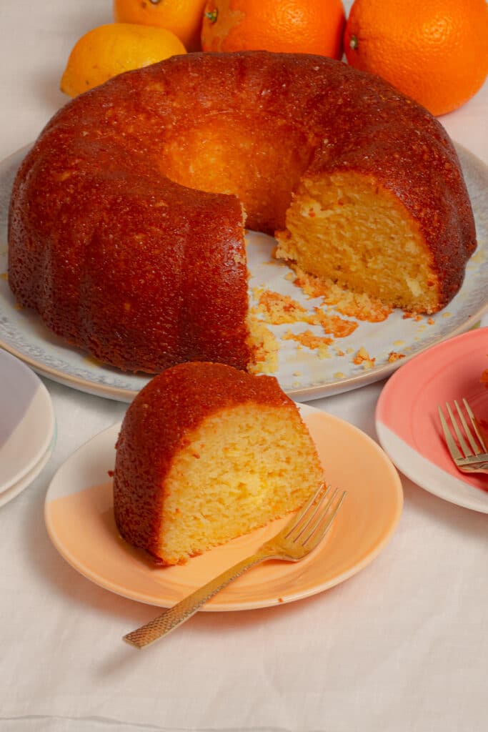 1 whole pound cake with one serving in a in orange dessert plate.