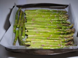 Asparagus lined in a baking sheet lined with parchment paper