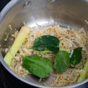 Sauteed aromatics- shallots, ginger, garlic, lime leaf and lemon grass in stainless steel sauce pan