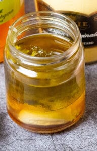 Apple cider-garlic vinaigrette in an open jar