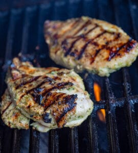 2 chicken breast in a barbeque grill.