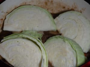 Sliced cabbage on top of the stewing beef to cook.