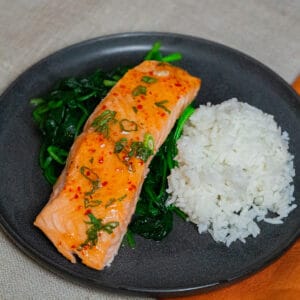 sweet chilli salmonon a bed of sauteed spinach and steamed whiterice