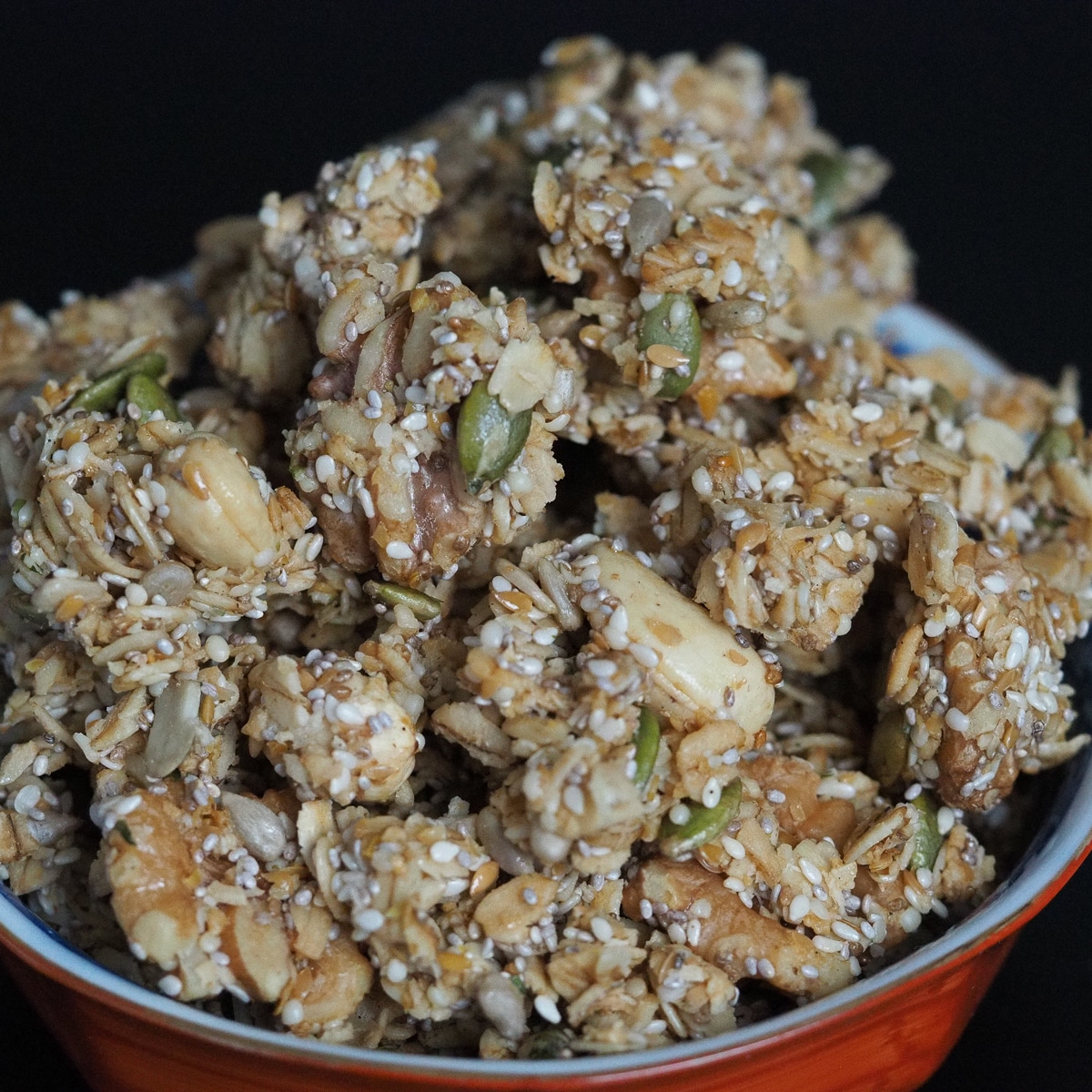Clusters of healthy granola in a blue and red bowl